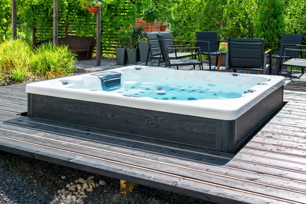 Outdoor spa on timber deck with patio furniture