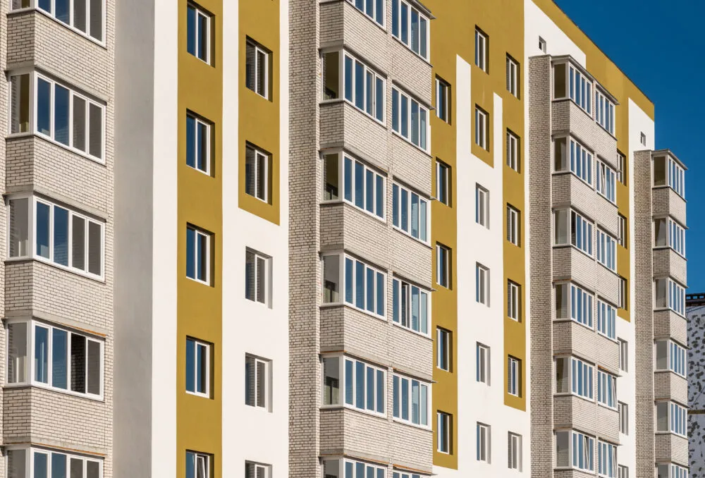 Modern apartment building with yellow and white facade