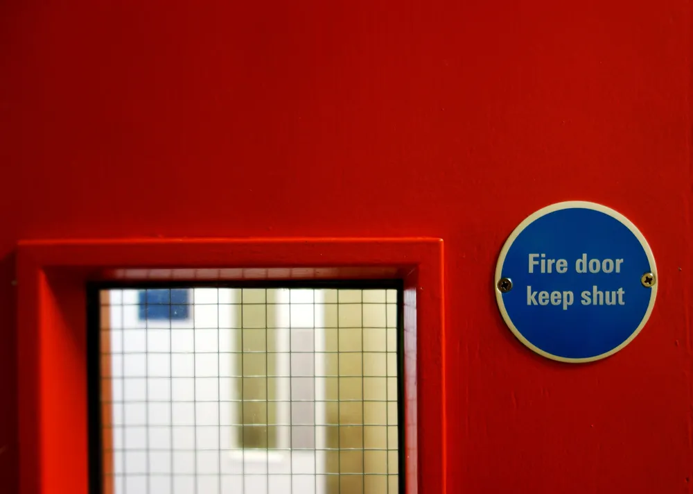 Red fire door with keep shut sign