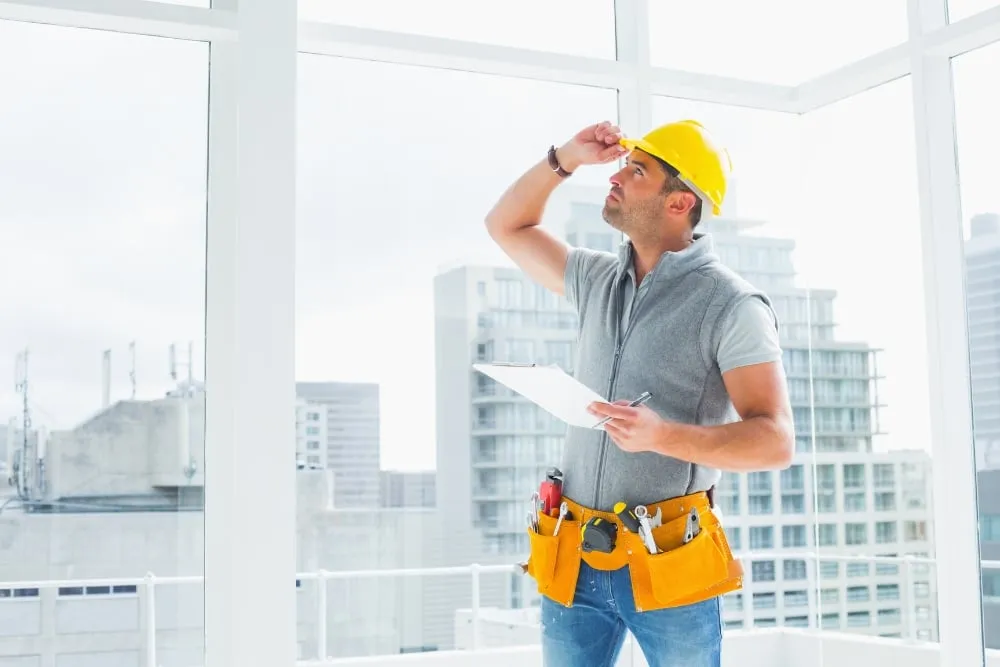 Construction worker inspecting high-rise apartment interior