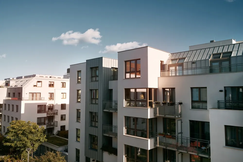 Modern apartment buildings with balconies under blue sky