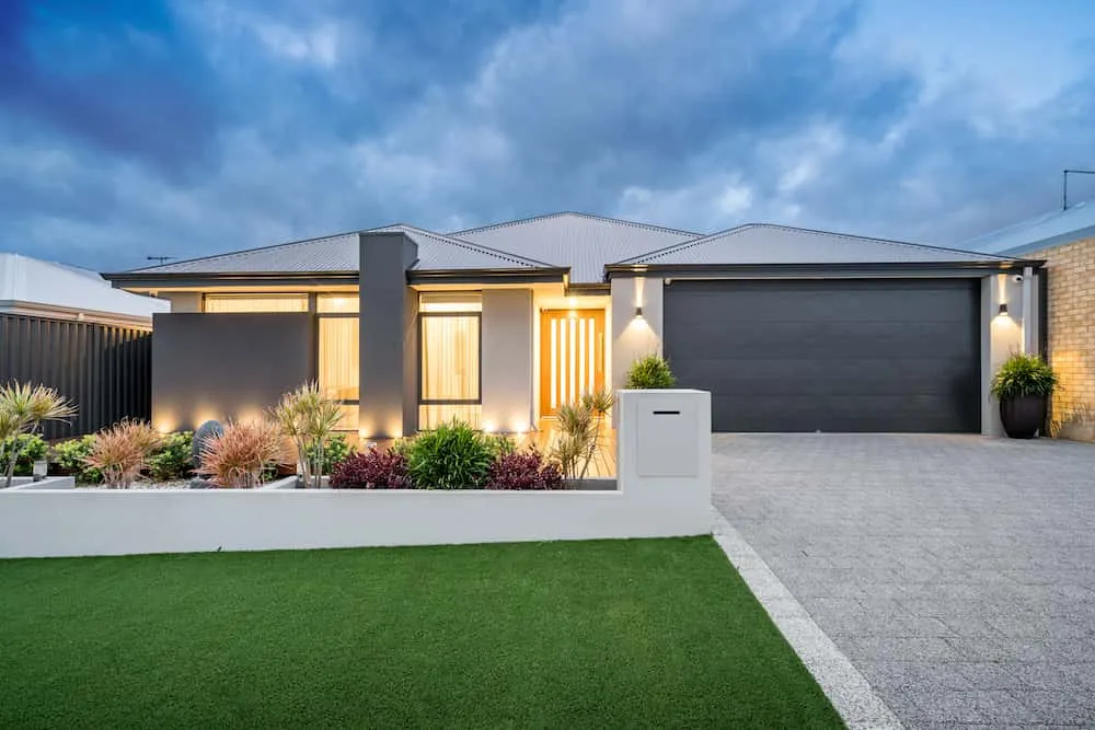 Modern single-storey home with landscaped garden at dusk