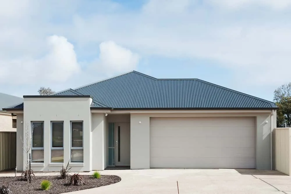 Modern single-storey home with double garage and metal roof