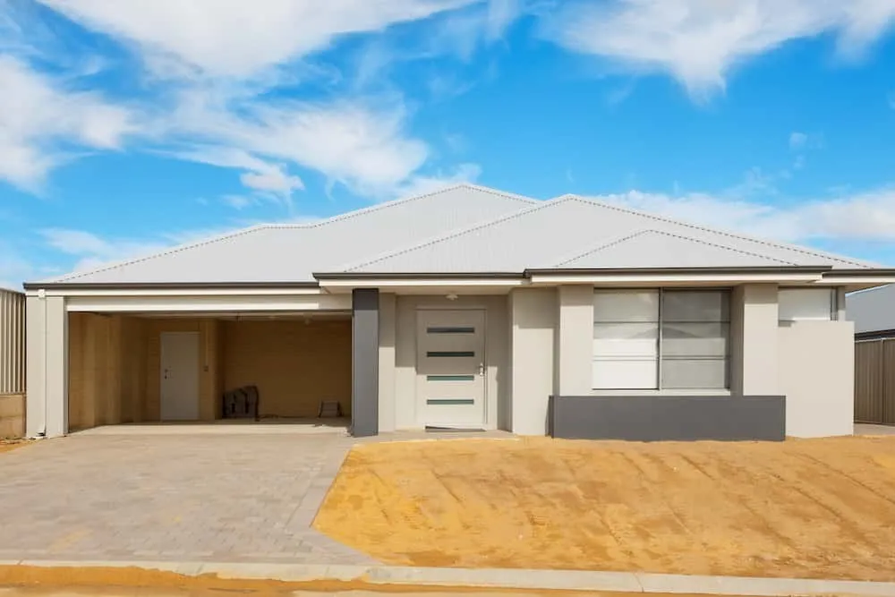 Modern single-storey home with double garage and sandy yard